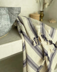 Cotton Turkish towel with purple stripes and tassels.