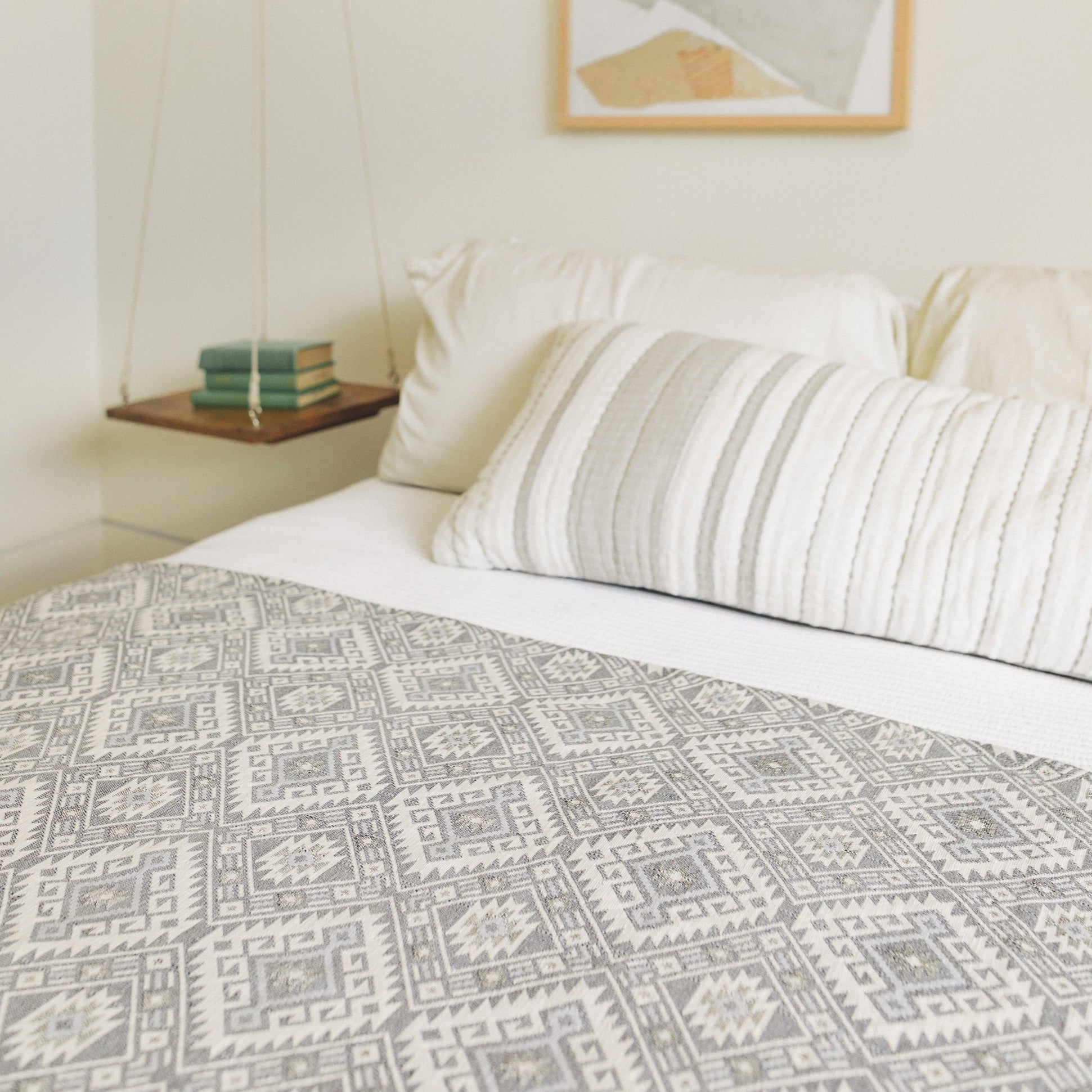 Kilim blanket in silver gray as a bed cover.