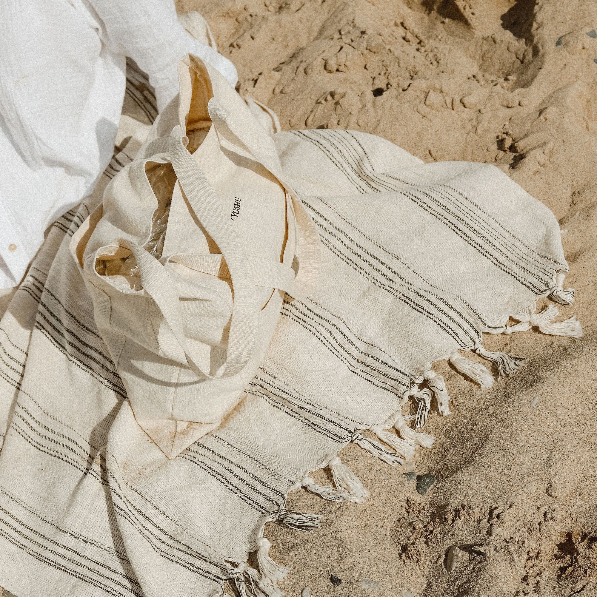 Mira handwoven towel at the beach.