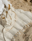 Mira handwoven towel at the beach.