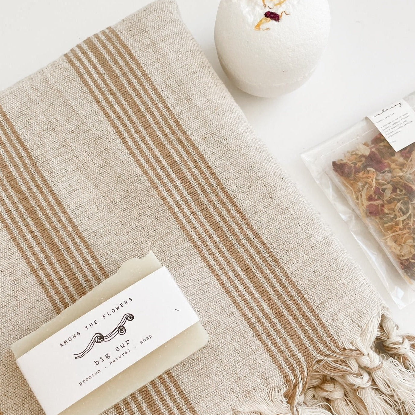 Sade Handwoven Towel Gift Box including a handwoven towel, bath bomb, floral bath tea and a bar soap from Among the Flowers.