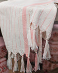 Cotton Turkish towel with light coral stripes.